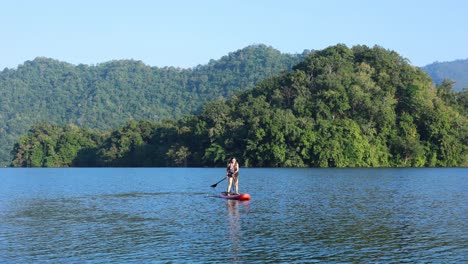 person kayaking on a calm, scenic lake