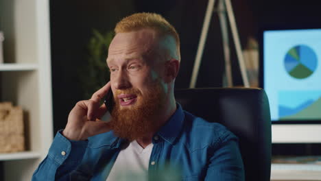 smiling hipster man talking on mobile phone at home. happy guy working at home.
