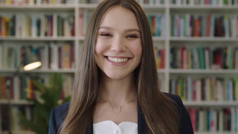 portrait of young beautiful woman standing in library student smiling laughing study learning
