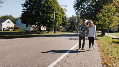 Couple-Walk-Down-Street-Holding-Hands