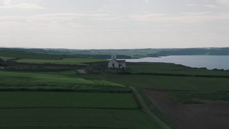 Rising-Flyover-of-Coastal-Church-with-Cliffs-and-Atlantic-Ocean