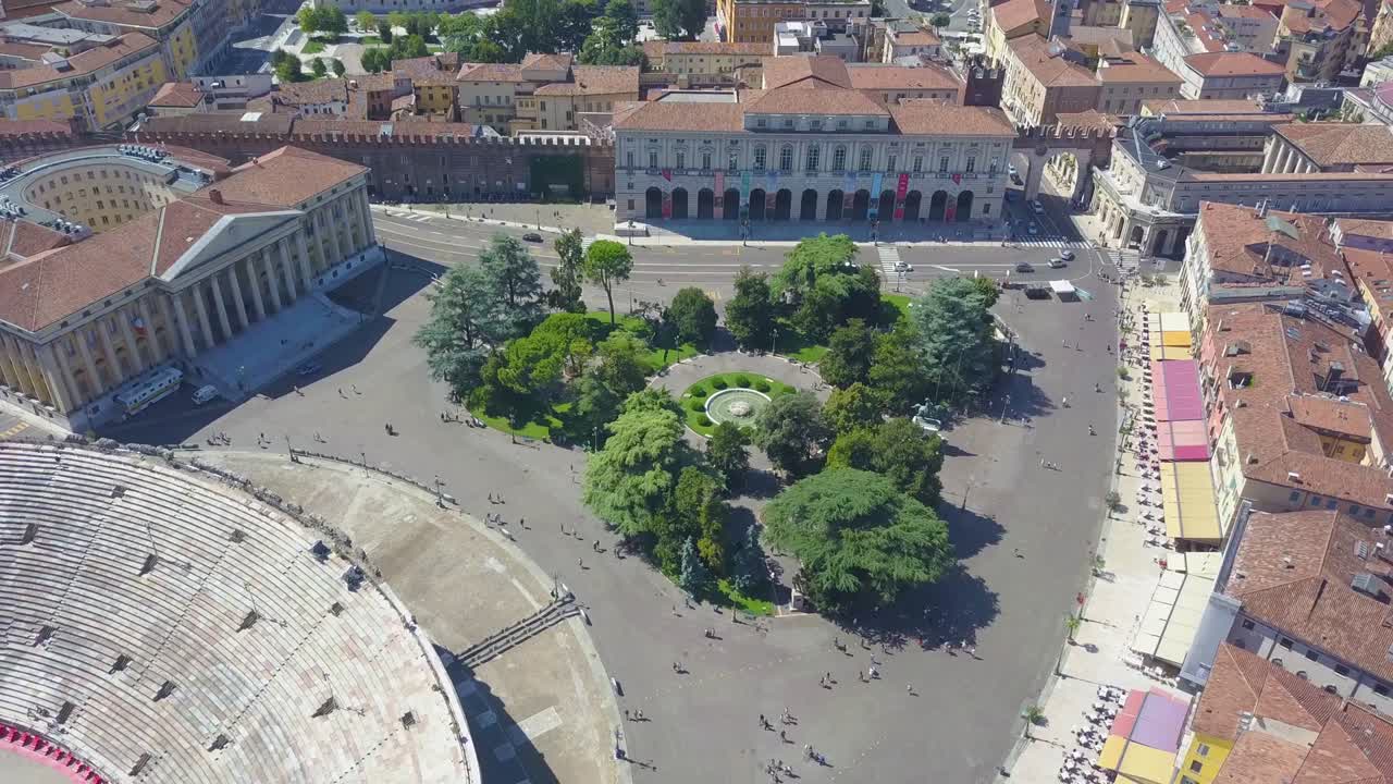 Aerial panoramic view of Arena di Verona, Italy. The drone flies over Bra Square and takes pictures of people walking. A view of the Arena and the city opens. 4k vieo.