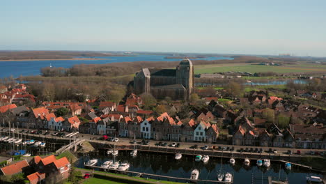 Aerial:-The-historical-town-of-Veere-with-an-old-harbour-and-churches,-on-a-spring-day