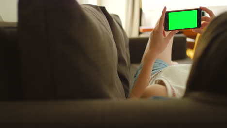 woman relaxing on couch with phone