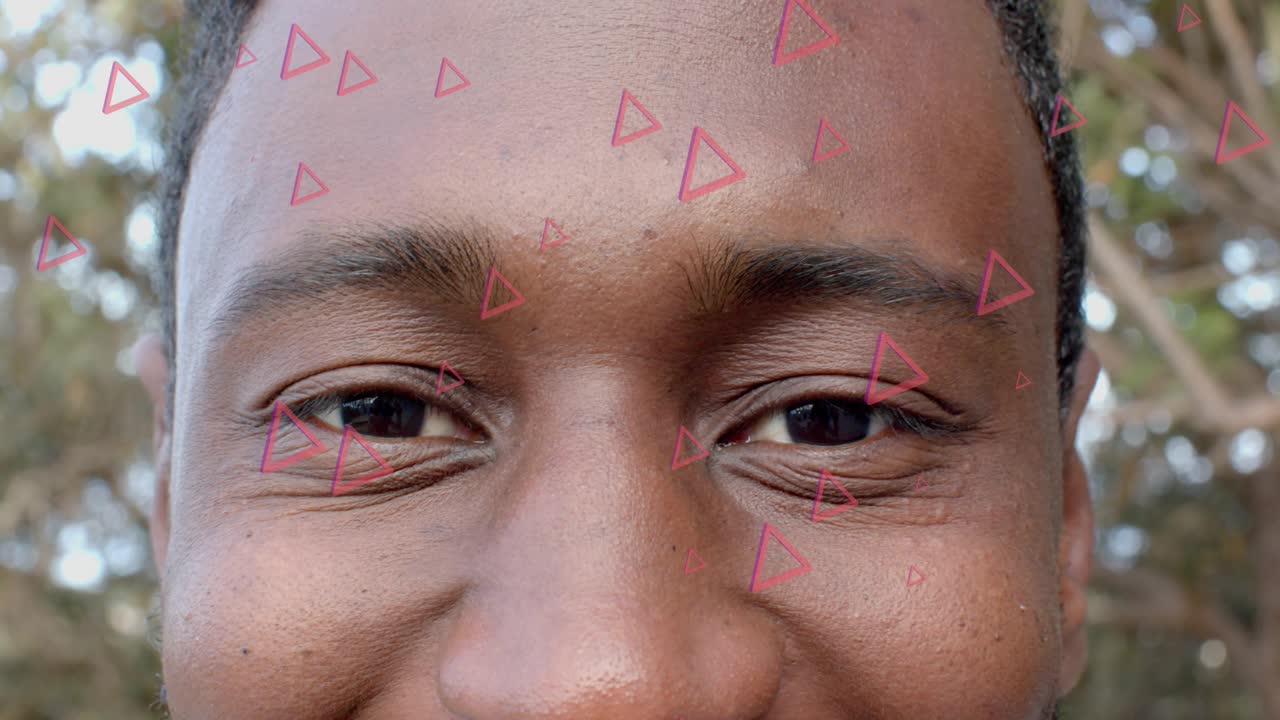 Magenta triangles appearing, mid-adult man opening eyes and smiling, reacting to AR overlays