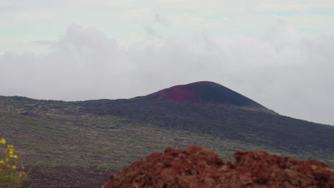 4K-Lookout-Of-Volcanic-Mountain-Over-Crater-Valley-With-Rocky-Foreground,-Mauna-Kea,-Hawaii,-Slow-Motion