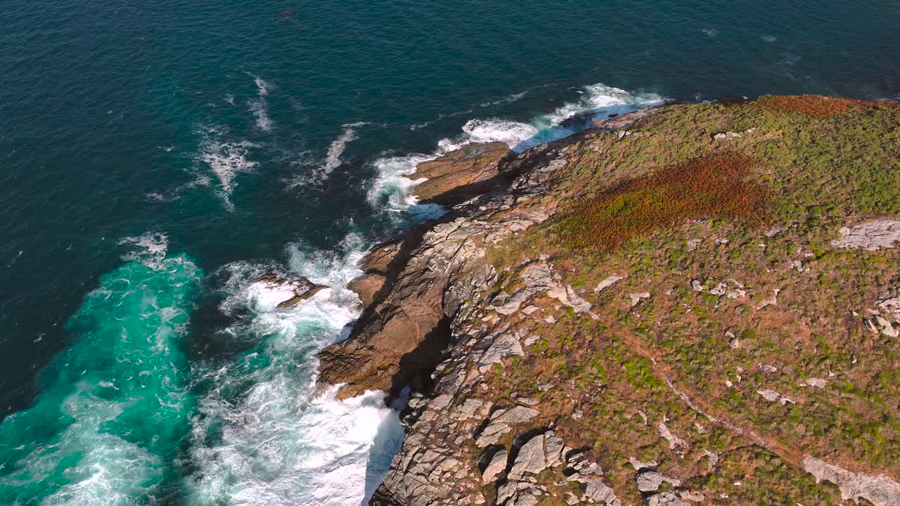 Foamy Waves Hitting The Rocky Coastline And Cliffs. - aerial shot