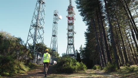 engineer walking to antenna