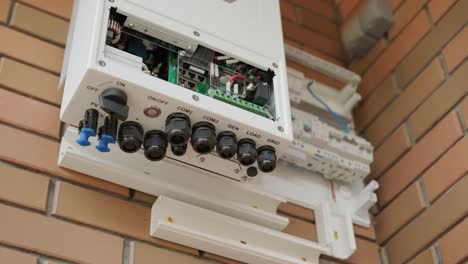 an electrician installing an inverter in a home. the image shows technical skill, modern tools, and attention to safety in electrical work