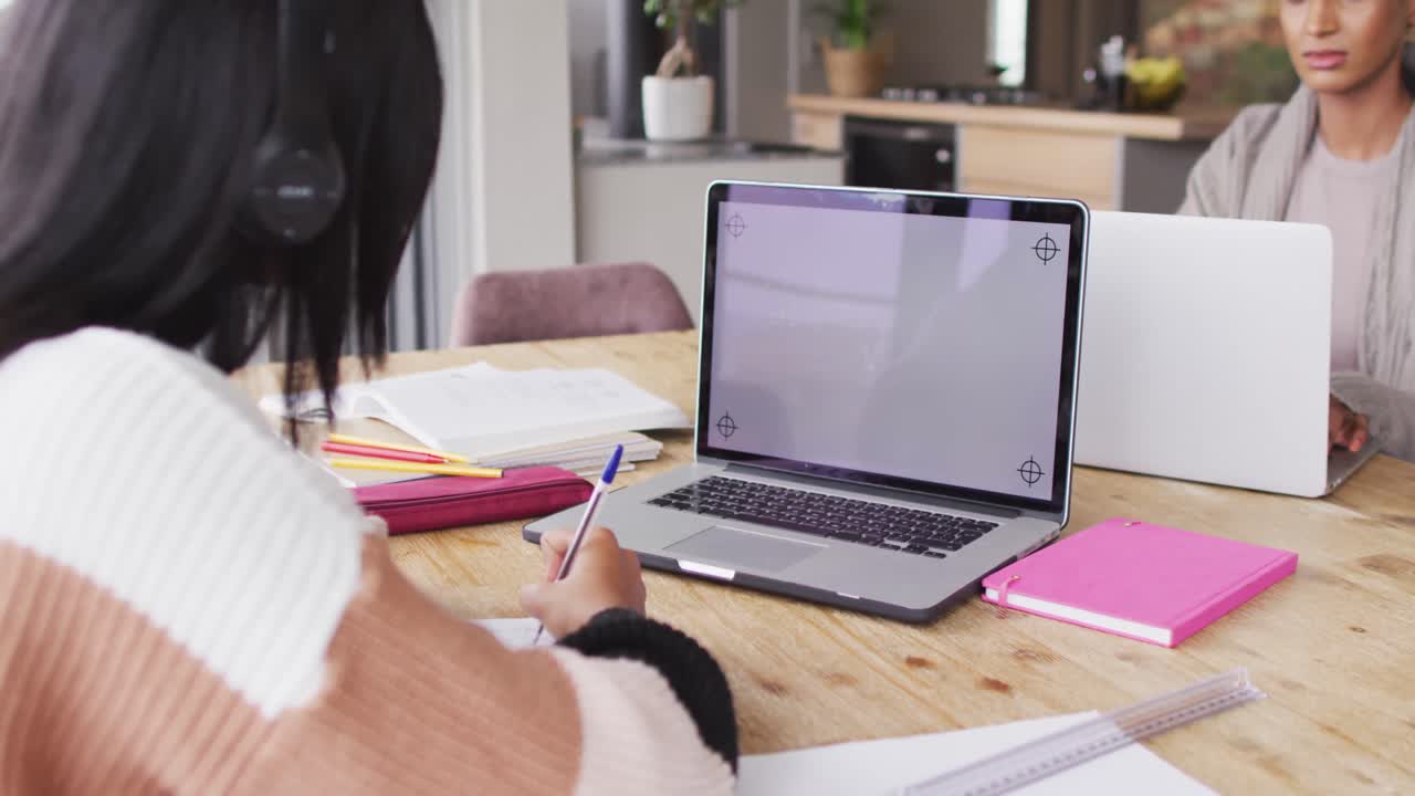 Video of biracial woman in headphones learning with laptop with copy space