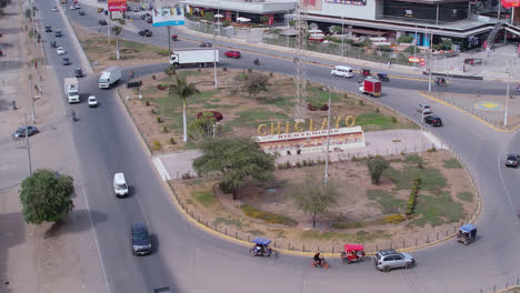 Beautiful-drone-shot-of-an-oval-on-a-Peruvian-highway-with-passing-cars-around