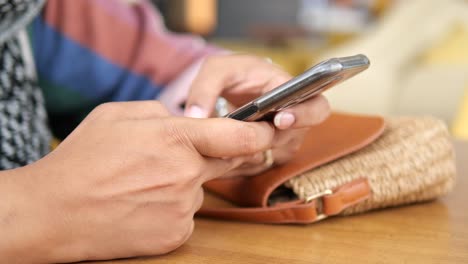 woman texting on her phone in a cafe