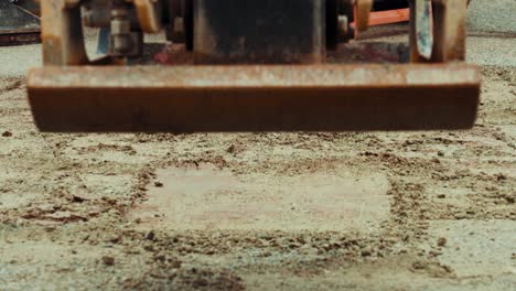 vibratory plate compactor machine compacting gravel on a city road