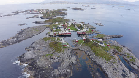 high areal shot orbiting around a small settlement on a nordic island