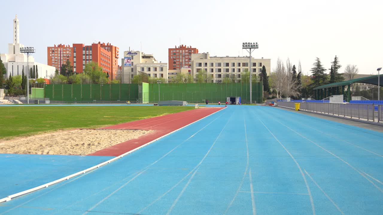 Two Athletes Running on a Track