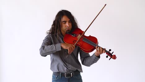 Long-hair-hispanic-male-musician-playing-red-viola-instrument-in-slow-motion-on-white-backdrop,-medium-shot