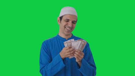 Happy-Muslim-man-counting-money-Green-screen