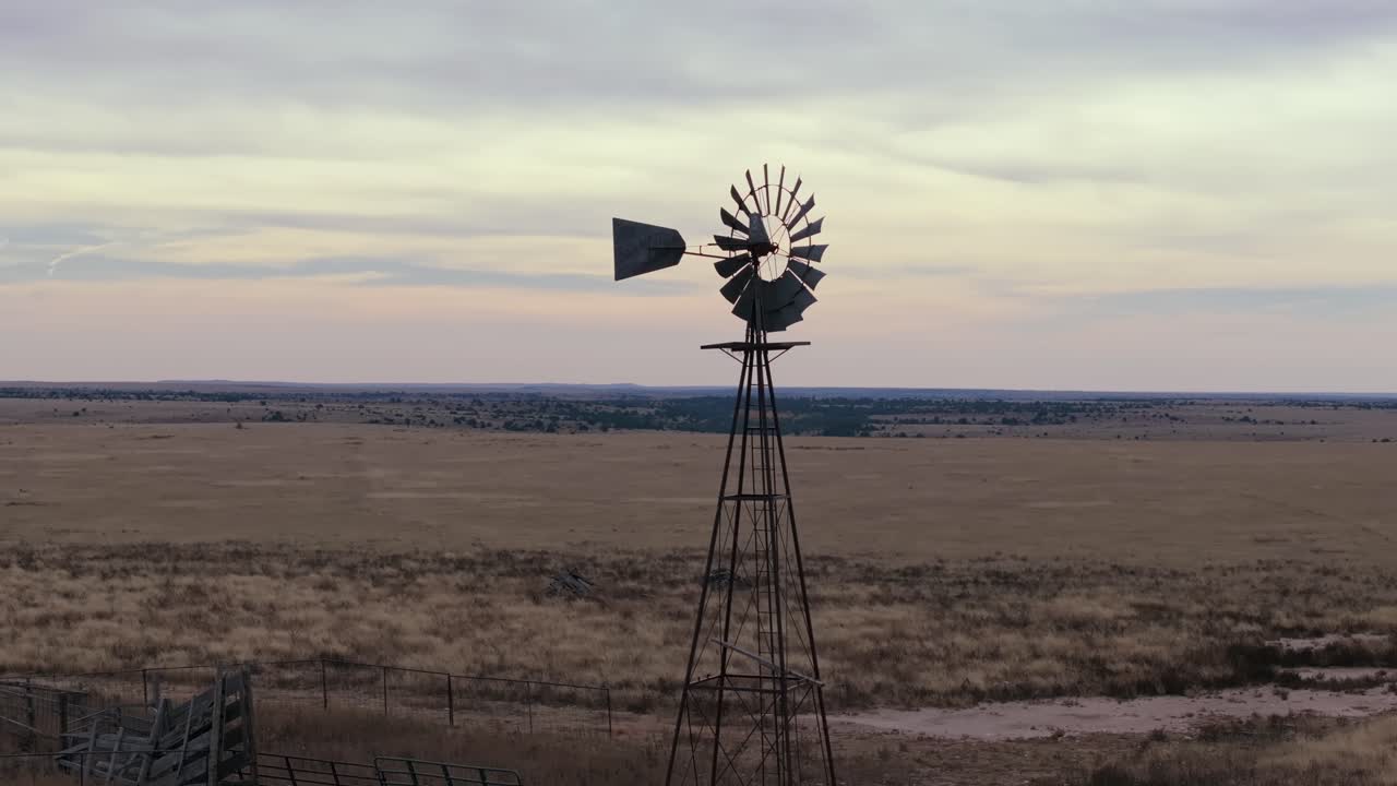 Windmill on vast plain at sunset, calm and serene mood, outdoors scene