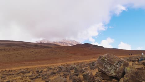 Time-lapse-shot-of-people-hiking-on-the-uhuru-trail,-towards-the-summit-of-mount-Kilimanjaro,-on-a-foggy-and-sunny-day,-in-Tanzania,-Africa