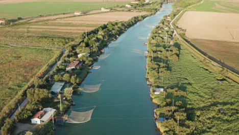 aerial view of fishing huts in the river, lido di dante, fiumi uniti, ravenna near comacchio valley