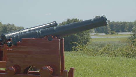 Panning-over-old-cannons-overlooking-typical-Dutch-landscape