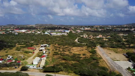 a small junkyard sitting at the bottom of hooiberg mountain in aruba