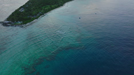 top down drone of deep reef system in dark and light turquoise tones