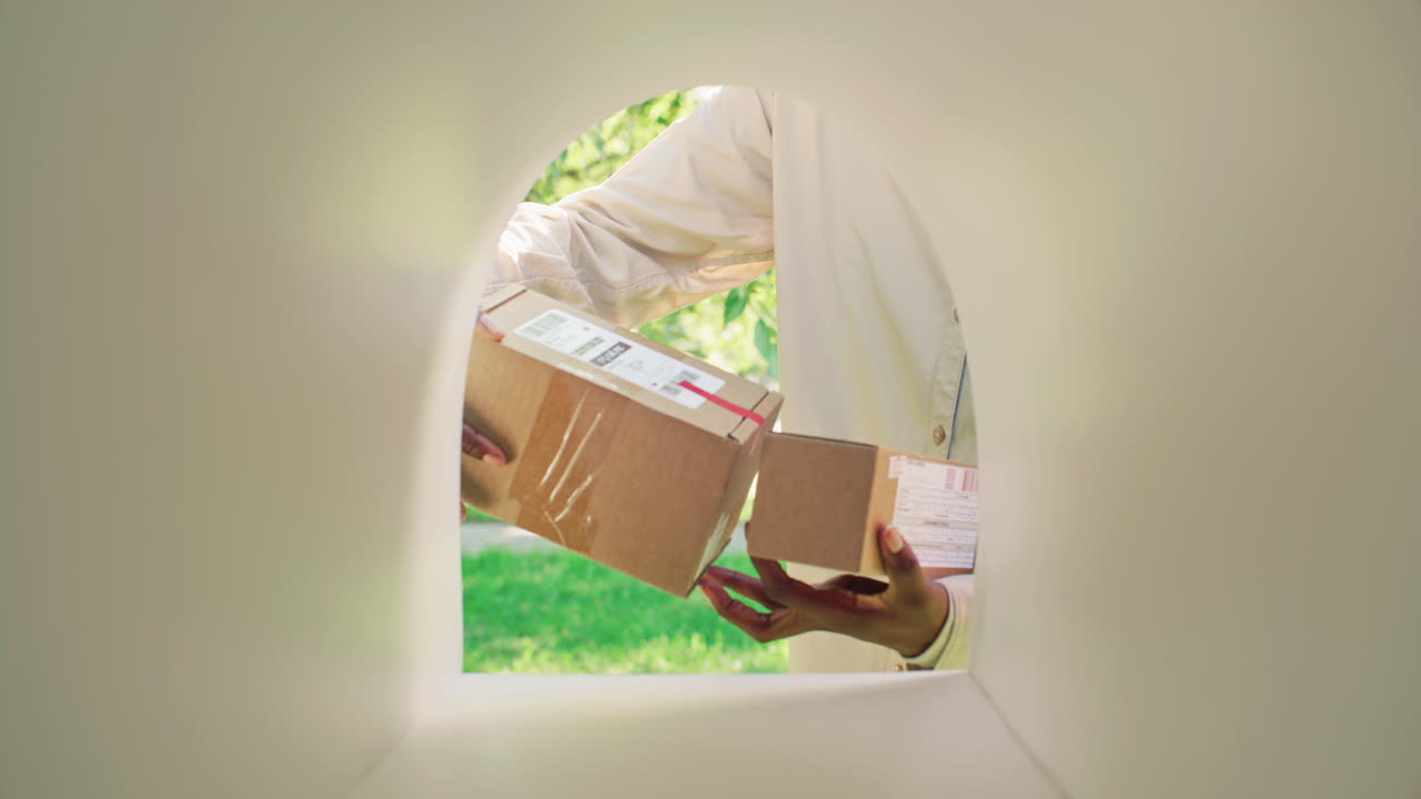 Black Woman Collecting Parcels from Mailbox on Street