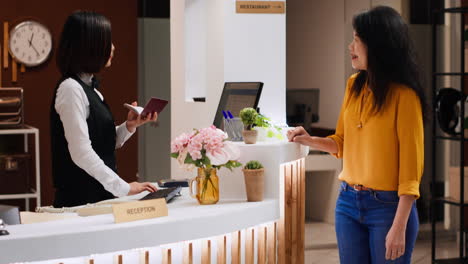 hotel worker looking at passport id for check in process