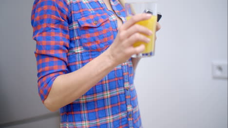 sexy bottomless woman drinking orange juice