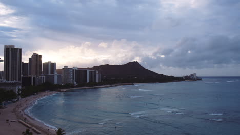 daybreak over diamond head summit and waikiki beach hotels, hawaii, wide shot