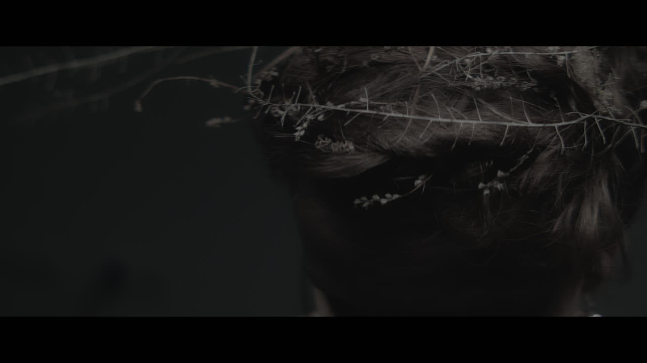 A woman dressed as mother nature shows her hair