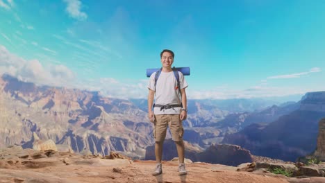 full body of asian male hiker with mountaineering backpack smiling to camera while traveling at the top of mountain