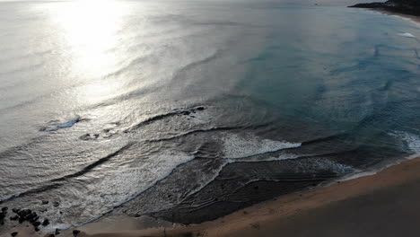 a drone shot of philippine sea in kenting national park, taiwan with camera approaching the sea during sunset