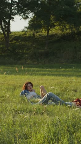 couple relaxing in a field at sunset