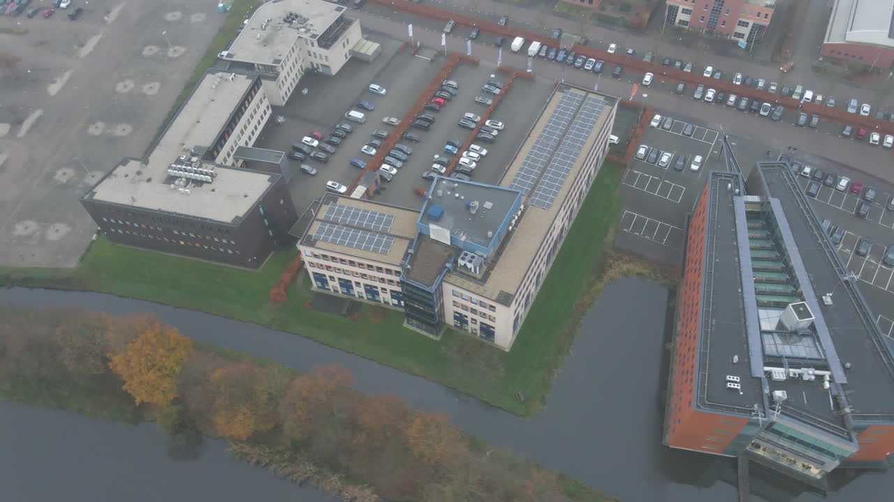 Aerial of office building with solar panels on rooftop