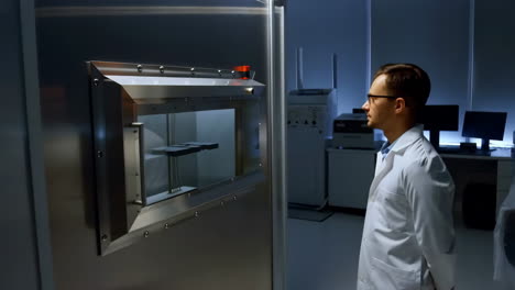 scientist observing advanced lab equipment in a research facility