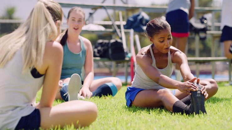 Group of young girl hockey players stretching