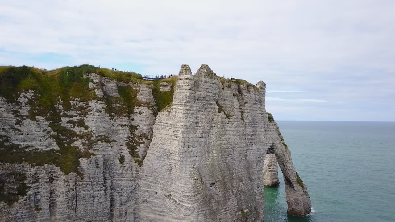 Flying upward looking over the arch of Etretat in Normandy, France