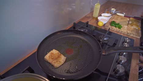 caribbean chef searing fish on a stove