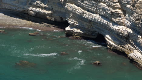 steep cliff with view of sea cave entrance