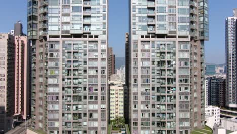 Aerial-shot-of-Downtown-Hong-Kong-mega-residential-skyscrapers-and-traffic,-on-a-beautiful-day