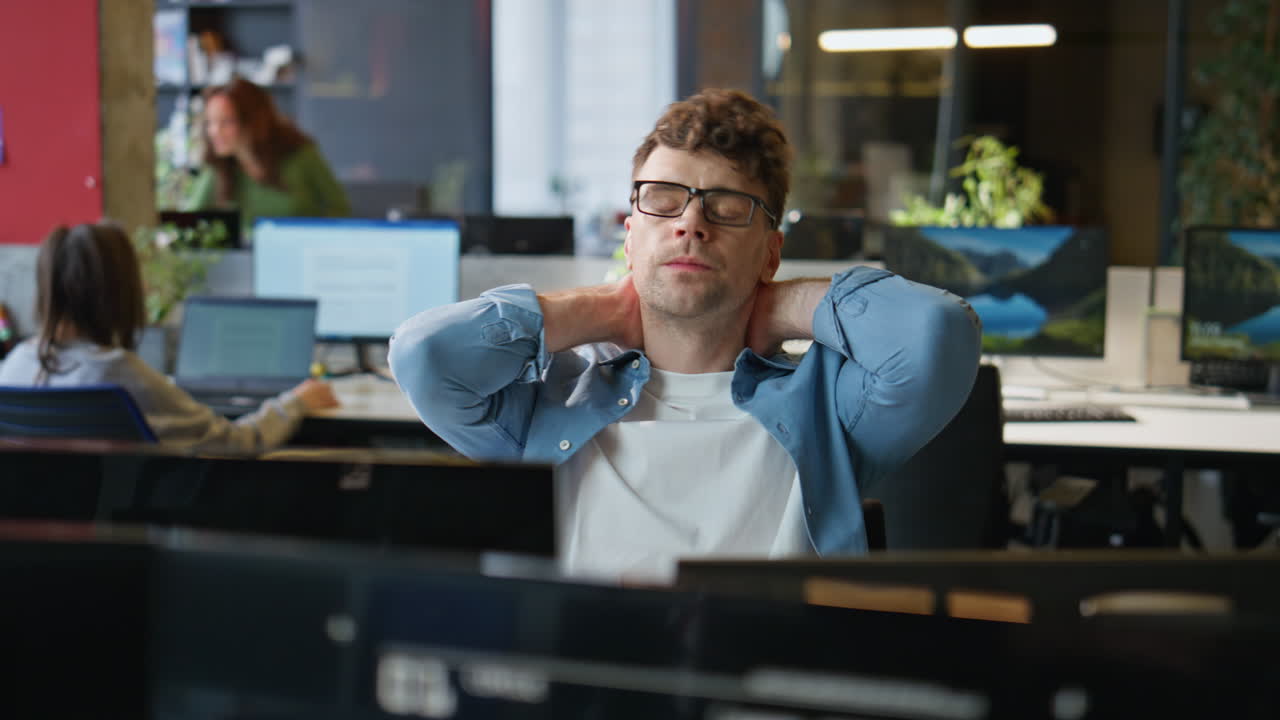 Tired guy looking computer taking break closeup. Office manager stretching body
