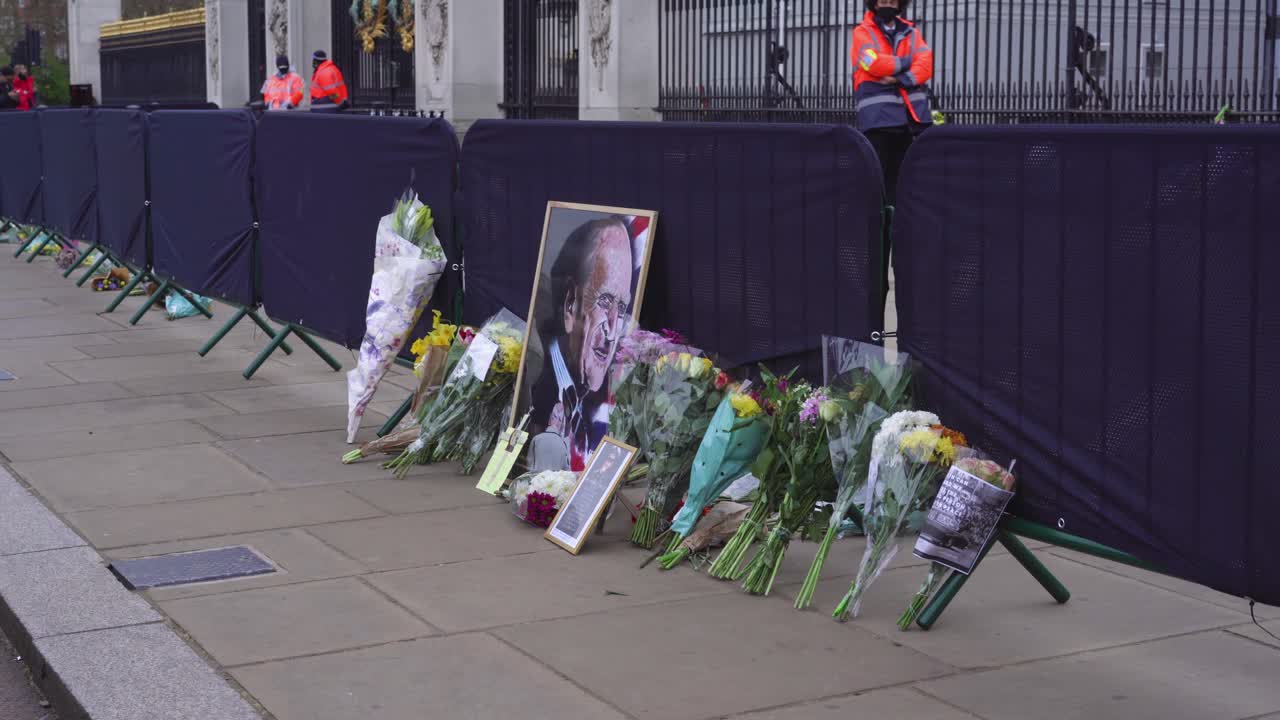 Buckingham Palace wide shot of tributes, flowers, notes, and paintings left by mourners to mark the death of Prince Philip, Duke of Edinburgh, Saturday April 10th, 2021 - London UK
