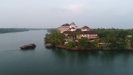 Drone-footage-of-a-luxurious-hotel-with-boat-and-lake-side