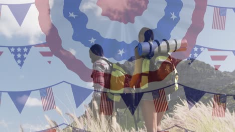 Animation-of-american-flag-over-smiling-diverse-couple-hiking-in-mountains