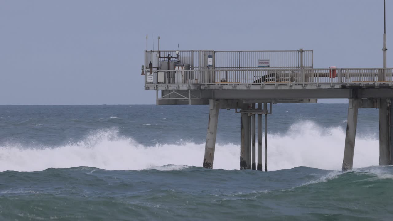 Waves impact a pier over an eleven-second span