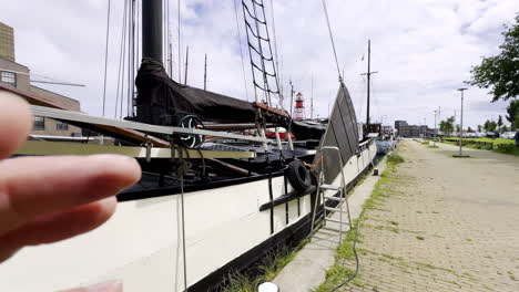 Glimpse into Maritime History Traditional Dutch Sailing Barge Moored in Den Helder, its Classic Lines and Colors Echoing a Bygone Era on a Partly Cloudy Day
