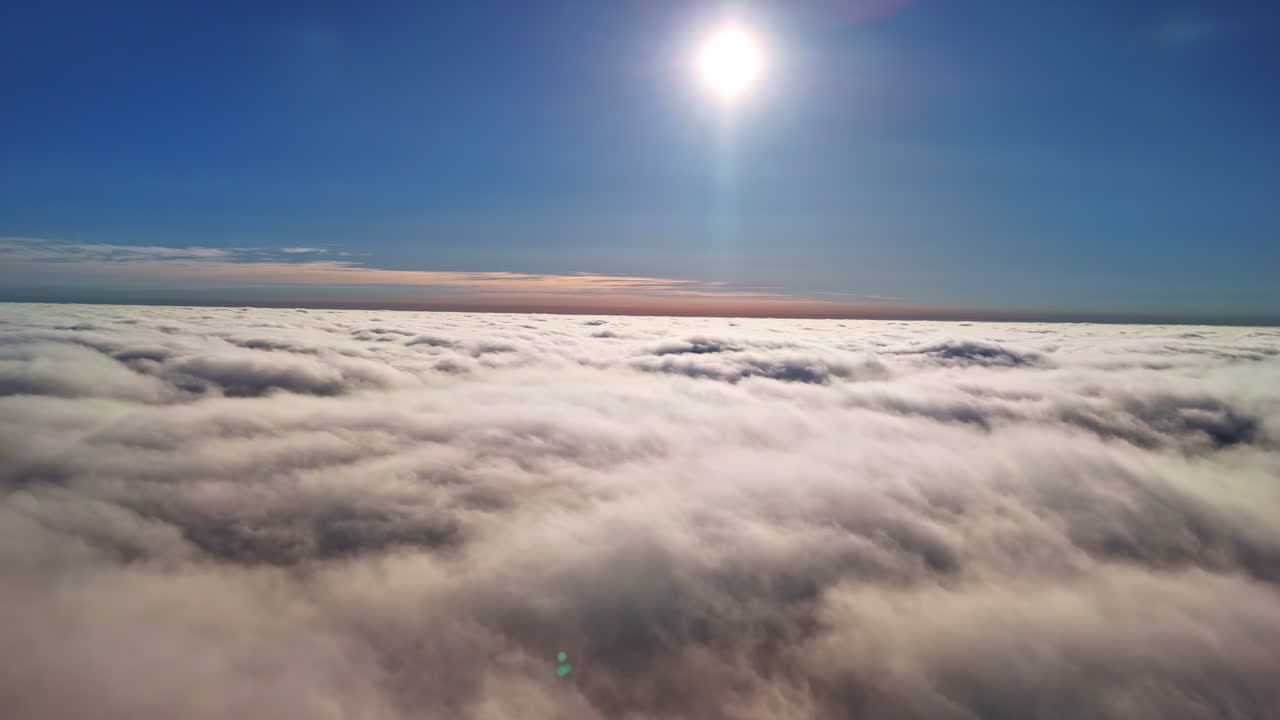 Flying above thick cloud cover with sun rays peeking through, soft gradient sky above, natural backdrop background