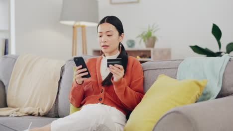 Happy-woman,-credit-card-and-phone-on-couch-online